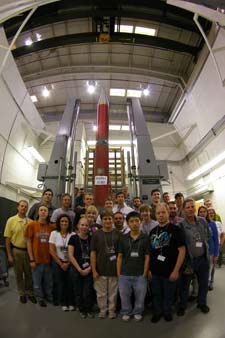 RockOn student group in front of rocket payload in spin balance bay